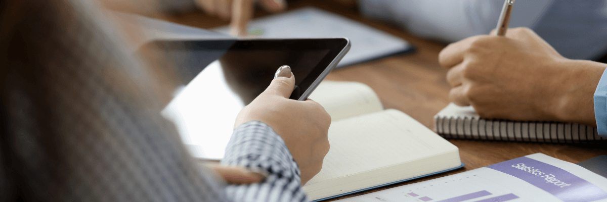 Business professional reading engaging content on a laptop in a modern office space.